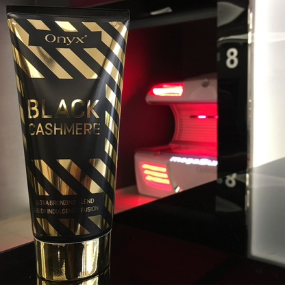 Onyx Black Cashmere przy kabinie solaryjnej – balsam bronzujący do ciała zapewniający ciemną, długotrwałą opaleniznę i pielęgnację skóry.